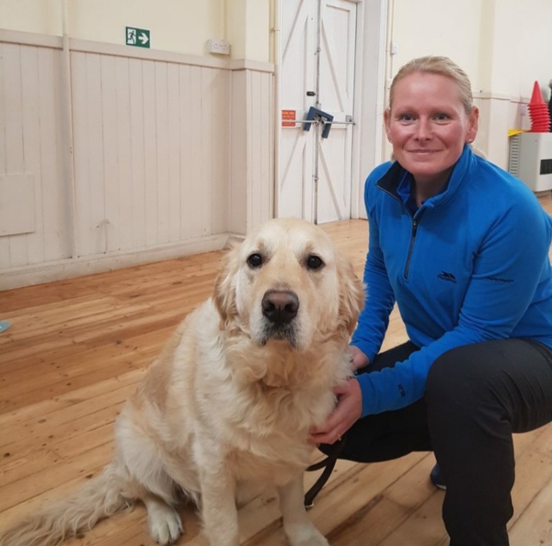 A Back To Basics trainer with a happy labrador